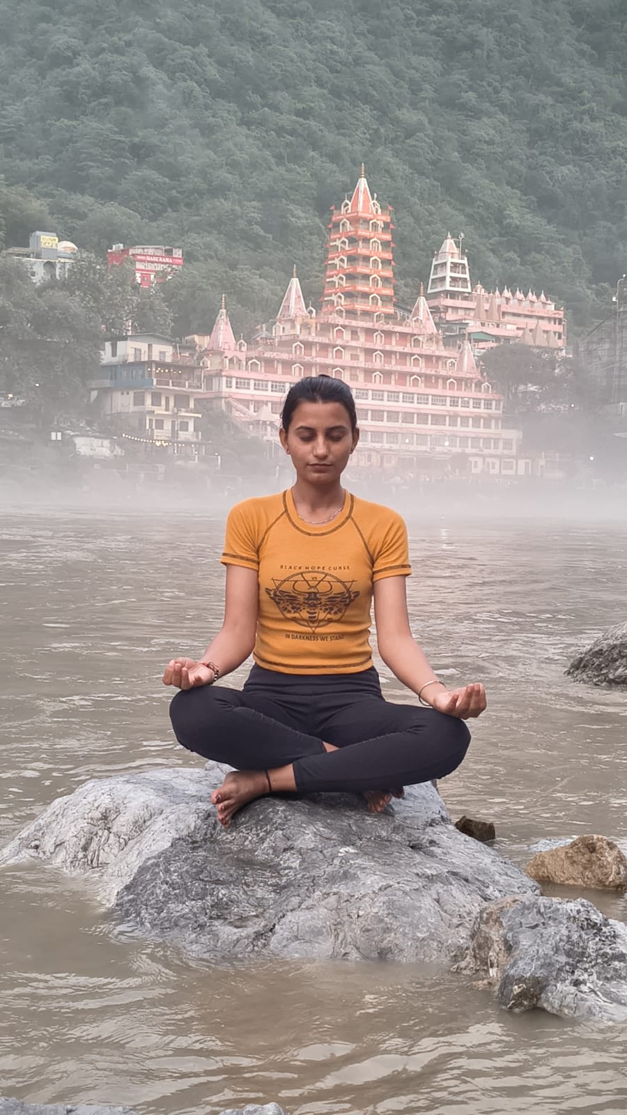 Priya Sheoran meditating on a rock in the Ganga at Rishikesh